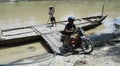 Residents crossing the river by boat solo canoe as a means of crossing to and from solo Central Java Indonesia. Royalty Free Stock Photo