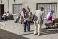 Residents of an elderly persons home in the old city seeking the warmth of the early morning sun in La Paz in Bolivia.