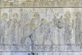 Residents of historical empire with animals. Stone bas-relief in ancient city Persepolis, Iran Royalty Free Stock Photo