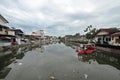 Residents use a boat across the river in slums Sangkrah