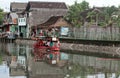 Residents use a boat across the river in slums Sangkrah