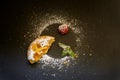 Residues after fruit tartlet. Decorated powdered sugar, raspberries and ment on black background Royalty Free Stock Photo