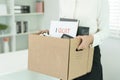 resignation, leave, quit, Stressful businesswomen will resign from the company. Female staff is lifting a brown paper box that Royalty Free Stock Photo