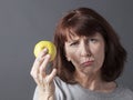 Resigned 50s woman with symbol of healthy lifestyle and fresh food Royalty Free Stock Photo