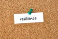 Resilience. Word written on a piece of paper, cork board background Royalty Free Stock Photo