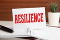 Resilience written on notepad on a table