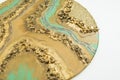 Resin art painting with golden colors and glass on white