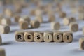 Resist - cube with letters, sign with wooden cubes