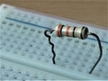 Resistor with metallic legs attached on top of a breadboard