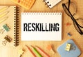 Reskilling text on sticky notes with office desk. Royalty Free Stock Photo