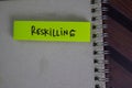 Reskilling write on sticky notes isolated on Wooden Table Royalty Free Stock Photo