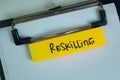 Reskilling write on sticky notes isolated on Wooden Table Royalty Free Stock Photo
