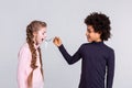 Resolute boy with wild hair feeding his girlfriend with headphones