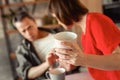 Resolute mindless dark-haired woman carrying heavy ceramic cup