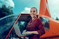 Resolute positive woman with wide smile carrying opened laptop