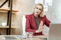 Resolute serious short-haired woman showing stopping gesture to laptop camera