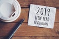 Resolution for 2019 word on paper with pen and coffee cup on wooden table. Business concept Royalty Free Stock Photo