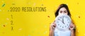 2020 Resolutions with young woman holding a clock