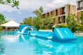 Resort pool with inflatable water obstacle Royalty Free Stock Photo