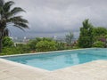 Resort pool overlooking San Jose, Costa Rica skyline against storm clouds. Royalty Free Stock Photo