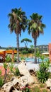 Resort scene with pool, lounge chairs and pine trees Royalty Free Stock Photo