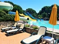 Resort scene with water slides, pool and lounge chairs in water park Royalty Free Stock Photo