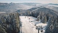 Resort at snow mountain aerial. Ski escalator at pine forest. Tourist landmark. Active winter sport Royalty Free Stock Photo