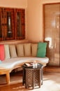 Resort style couch and wood table with colourful fabric cusion a