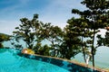 Infinity edge pool with blue sea and clear sky. Wide angle shot Royalty Free Stock Photo