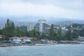 Resort town Gurzuf, buildings beach mountains plunged in a fog cloudy sky, view from the sea. Southern coast of the