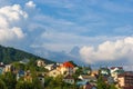 Resort village in mountain valley against the blue sky with clouds, summer landscape Royalty Free Stock Photo