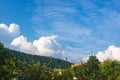 Resort village in mountain valley against the blue sky with clouds, summer landscape Royalty Free Stock Photo