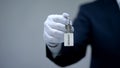 Resort word on keychain in receptionist hand, luxury housing rentals on vacation