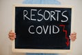 Resorts covid crisis. Coronavirus concept. Boy hold inscription on the board