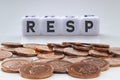 RESP letters on white blocks with coins on a clear background