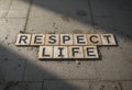 Respect Life Message Displayed on Tile Surface with Sunlight Shadows Royalty Free Stock Photo