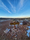 Respect Mother Earth signboard on a rocky desert landscape under a clear sky