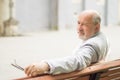 Respectable elderly man sitting on a bench