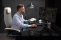 Business man with glasses working in office at computer table and drinking coffee from bright Cup Royalty Free Stock Photo