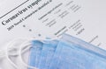 Respirator mask and closeup paper with text Coronavirus