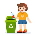 Responsibility of young little girl throwing plastic bottle in recycling trash bin.