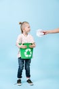 Responsible child is holding recycling bin for paper. Royalty Free Stock Photo