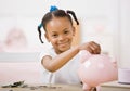 Responsible girl putting money into piggy bank Royalty Free Stock Photo