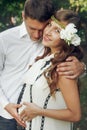 Responsible husband hugging beautiful stylish wife in retro whit