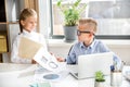 Responsible joyful children are analyzing data in office Royalty Free Stock Photo