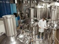 Responsible man standing in machinery at beer factory