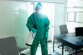 Responsible specialist sanitizing the office during COVID-19 pandemic Royalty Free Stock Photo