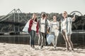 Responsible teacher and four active students volunteering near the river together Royalty Free Stock Photo