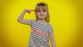 Responsible teen child kid girl giving salute listening to order as if soldier, following discipline Royalty Free Stock Photo