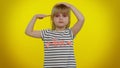 Responsible teen child kid girl giving salute listening to order as if soldier, following discipline Royalty Free Stock Photo